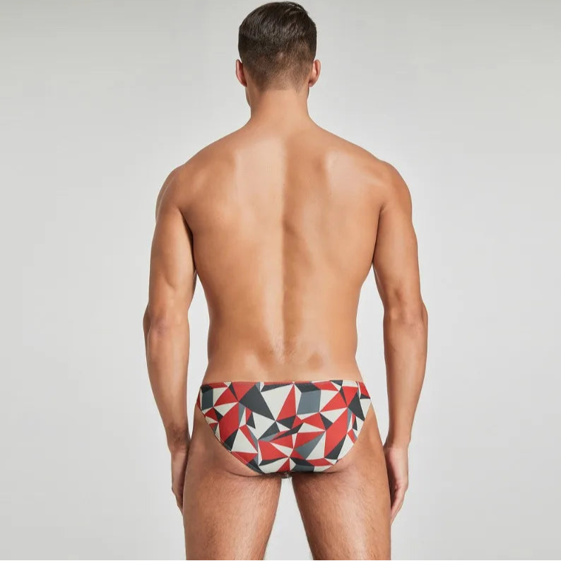 a sexy man in red Men’s Prism Tease Swim Briefs - pridevoyageshop.com - gay men’s sexy swim briefs, trunks, board shorts, and bikinis