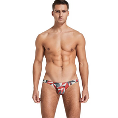 a sexy man in red Men’s Prism Tease Swim Briefs - pridevoyageshop.com - gay men’s sexy swim briefs, trunks, board shorts, and bikinis