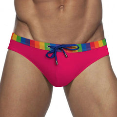 a sexy man in rose red Men’s Pride Patrol Rainbow Band Swim Briefs - pridevoyageshop.com - gay men’s sexy swim briefs, trunks, board shorts, and bikinis

