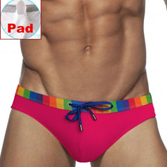 a sexy man in rose red Men’s Pride Patrol Rainbow Band Swim Briefs with pad - pridevoyageshop.com - gay men’s sexy swim briefs, trunks, board shorts, and bikinis