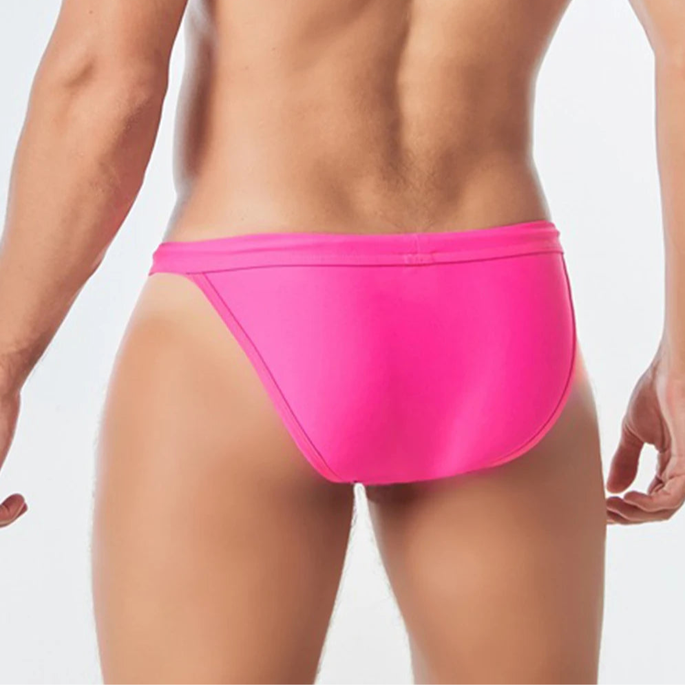 a sexy man in rose red Men’s Wet Package Micro Swim Briefs - pridevoyageshop.com - gay men’s sexy swim briefs, trunks, board shorts, and bikinis