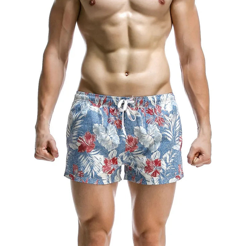 a sexy man in sky blue Men’s Tap-Ready Tides Swim Beach Surf Shorts – pridevoyageshop.com – gay men’s sexy swim briefs, trunks, board shorts, and bikinis