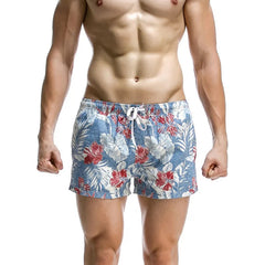 a sexy man in sky blue Men’s Tap-Ready Tides Swim Beach Surf Shorts – pridevoyageshop.com – gay men’s sexy swim briefs, trunks, board shorts, and bikinis