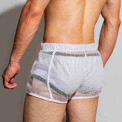a sexy man in white DM Men’s Trade Bait See-Thru Mesh Shorts – pridevoyageshop.com – gay men’s sexy swim briefs, trunks, board shorts, and bikinis