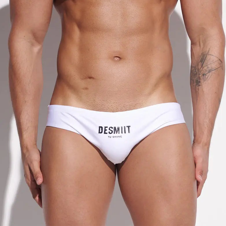 a sexy man in white Desmiit Men’s Sleek Statement Swim Briefs - pridevoyageshop.com - gay men’s sexy swim briefs, trunks, board shorts, and bikinis