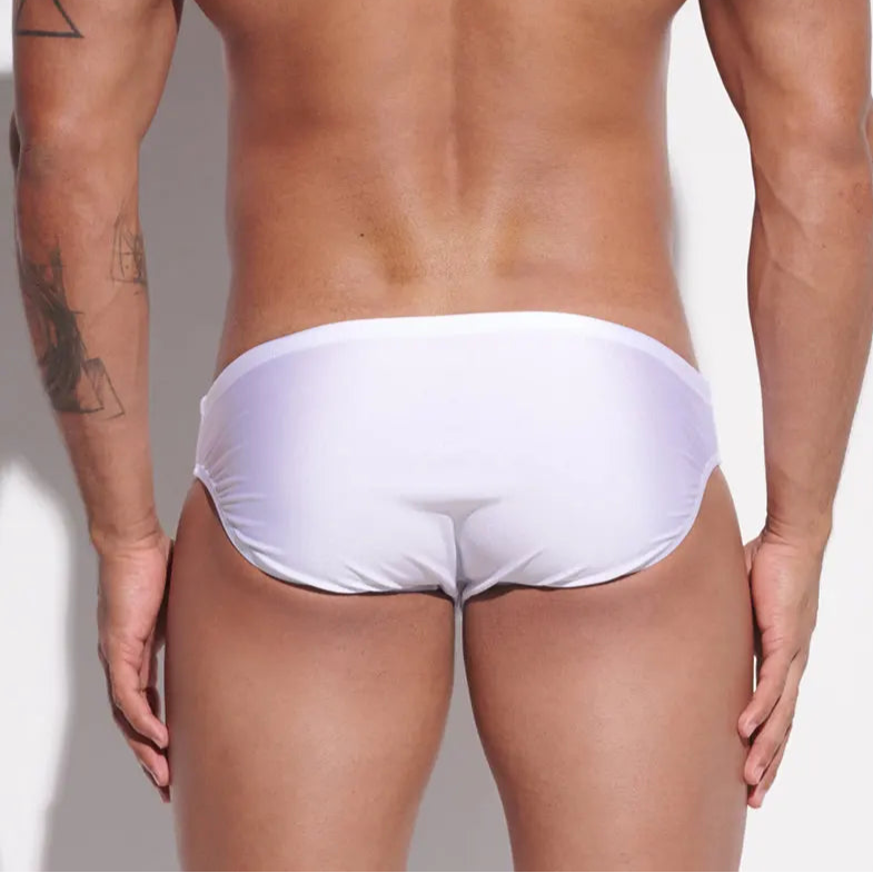 a sexy man in white Desmiit Men’s Sleek Statement Swim Briefs - pridevoyageshop.com - gay men’s sexy swim briefs, trunks, board shorts, and bikinis