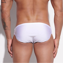 a sexy man in white Desmiit Men’s Sleek Statement Swim Briefs - pridevoyageshop.com - gay men’s sexy swim briefs, trunks, board shorts, and bikinis