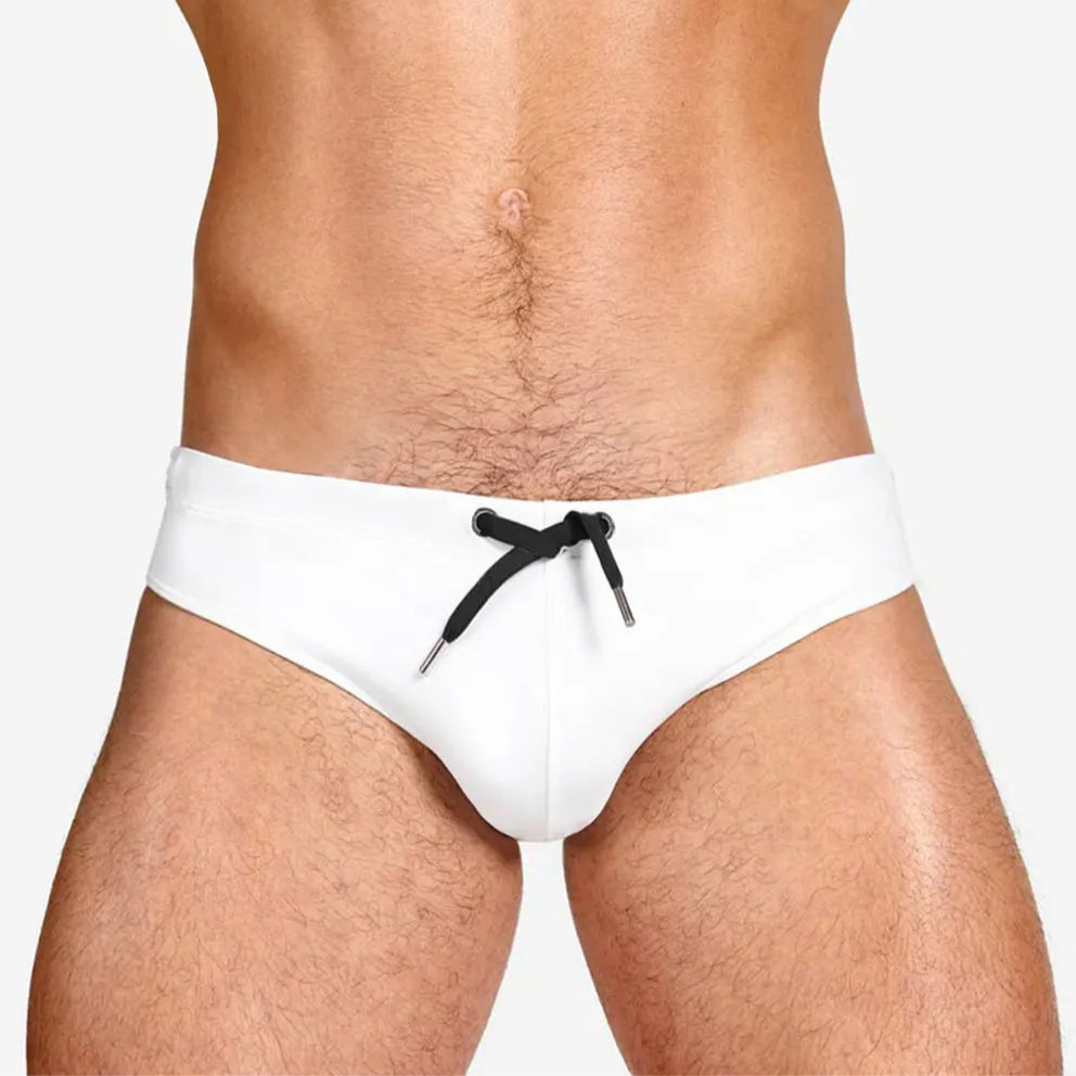 a sexy man in white Men’s Beach Brat Swim Briefs - pridevoyageshop.com - gay men’s sexy swim briefs, trunks, board shorts, and bikinis