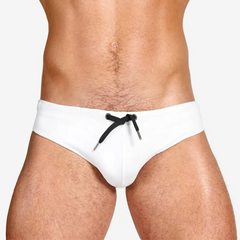a sexy man in white Men’s Beach Brat Swim Briefs - pridevoyageshop.com - gay men’s sexy swim briefs, trunks, board shorts, and bikinis