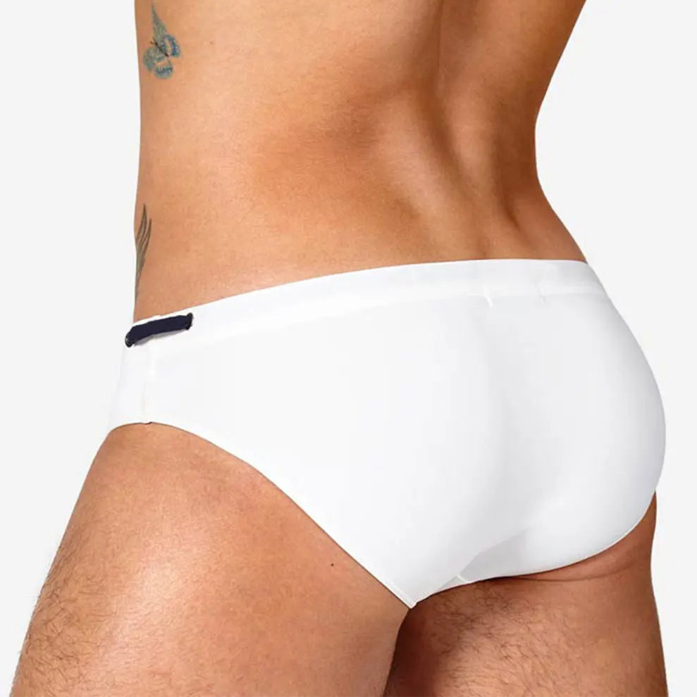 a sexy man in white Men’s Beach Brat Swim Briefs - pridevoyageshop.com - gay men’s sexy swim briefs, trunks, board shorts, and bikinis