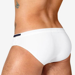a sexy man in white Men’s Beach Brat Swim Briefs - pridevoyageshop.com - gay men’s sexy swim briefs, trunks, board shorts, and bikinis