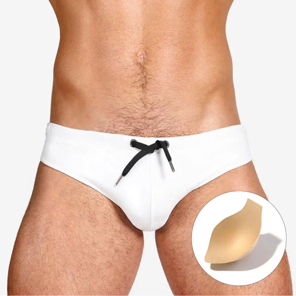 a sexy man in white Men’s Beach Brat Swim Briefs with pad - pridevoyageshop.com - gay men’s sexy swim briefs, trunks, board shorts, and bikinis
