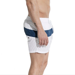 a sexy man in white Men’s Block Party Volley Swim Short – pridevoyageshop.com – gay men’s sexy swim briefs, trunks, board shorts, and bikinis