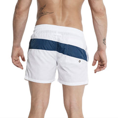 a sexy man in white Men’s Block Party Volley Swim Short – pridevoyageshop.com – gay men’s sexy swim briefs, trunks, board shorts, and bikinis