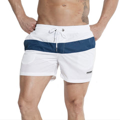 a sexy man in white Men’s Block Party Volley Swim Short – pridevoyageshop.com – gay men’s sexy swim briefs, trunks, board shorts, and bikinis
