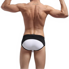 a sexy man in white Men’s Brave Package Swim Briefs - pridevoyageshop.com - gay men’s sexy swim briefs, trunks, board shorts, and bikinis