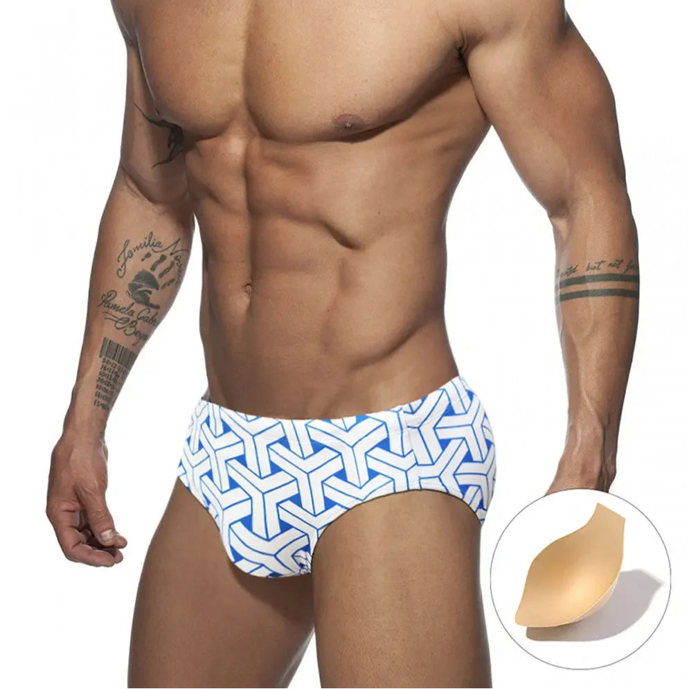 a sexy man in white Men’s Brickhouse Booty Swim Briefs with pad - pridevoyageshop.com - gay men’s sexy swim briefs, trunks, board shorts, and bikinis