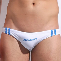a sexy man in white Men’s Fast & Curious Skinny Swim Briefs - pridevoyageshop.com - gay men’s sexy swim briefs, trunks, board shorts, and bikinis