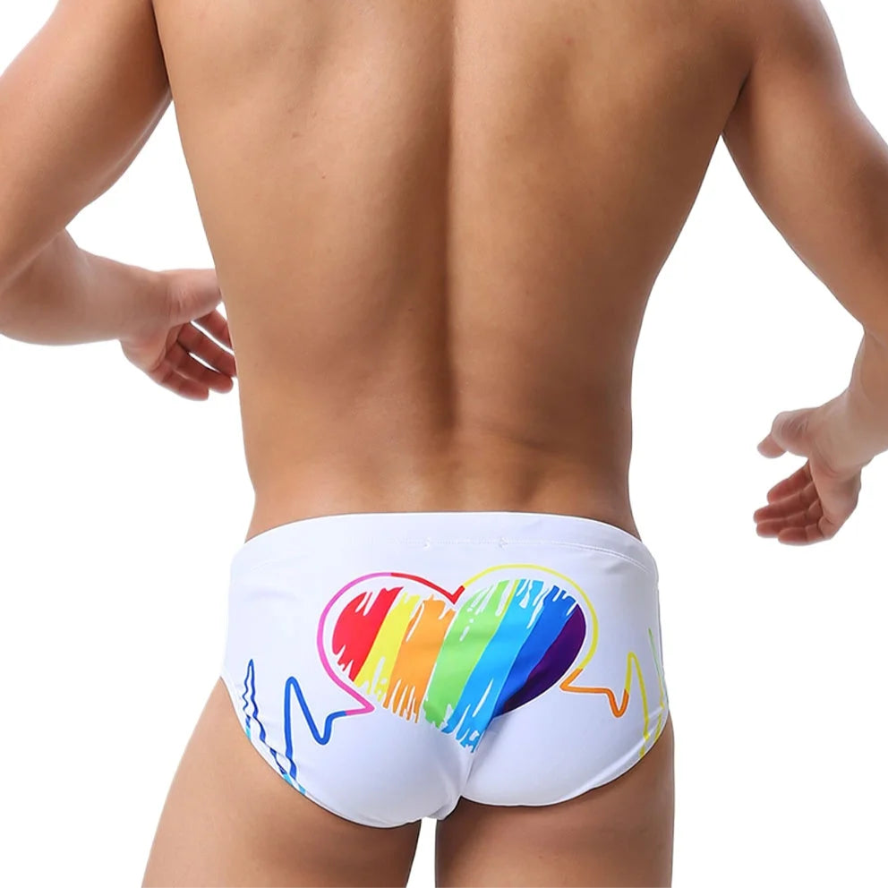 a sexy man in white Men’s Rainbow Heartbeat Swim Briefs - pridevoyageshop.com - gay men’s sexy swim briefs, trunks, board shorts, and bikinis