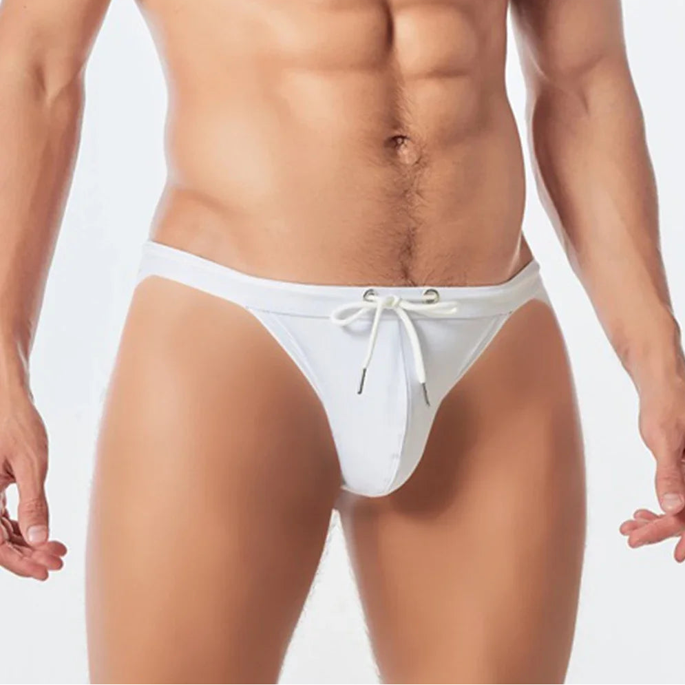a sexy man in white Men’s Wet Package Micro Swim Briefs - pridevoyageshop.com - gay men’s sexy swim briefs, trunks, board shorts, and bikinis