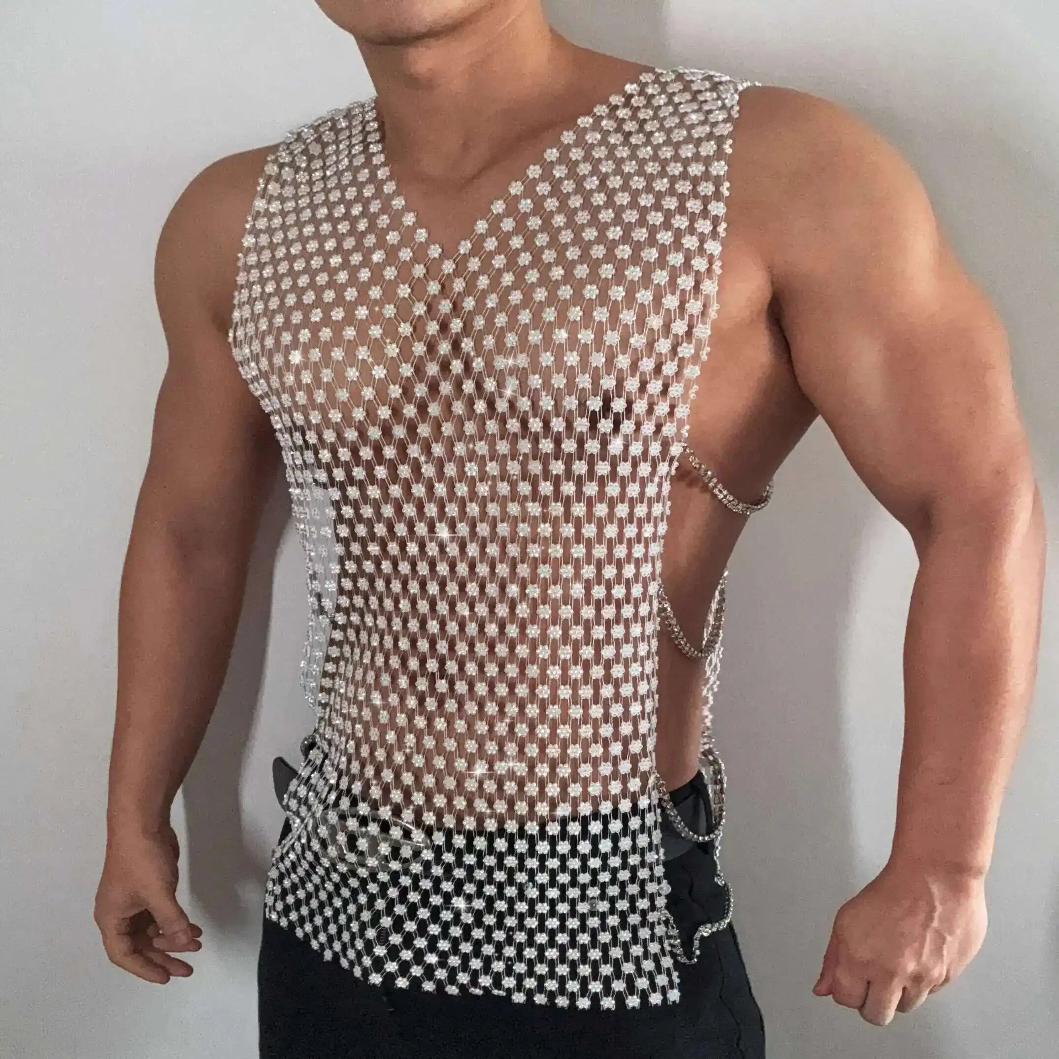 a sexy man in white crystal net tank revealing defined chest and shimmering rhinestones – pridevoyageshop.com – gay men’s harness, lingerie and fetish wear