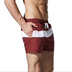 a sexy man in wine red Men’s Block Party Volley Swim Short – pridevoyageshop.com – gay men’s sexy swim briefs, trunks, board shorts, and bikinis