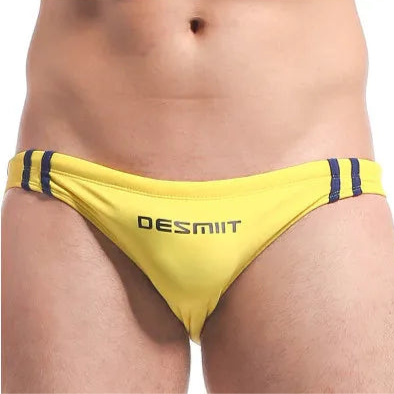 a sexy man in yellow Men’s Fast & Curious Skinny Swim Briefs - pridevoyageshop.com - gay men’s sexy swim briefs, trunks, board shorts, and bikinis