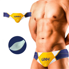 a sexy man in yellow Men’s Halftime Hard-On Swim Briefs with pad - pridevoyageshop.com - gay men’s sexy swim briefs, trunks, board shorts, and bikinis