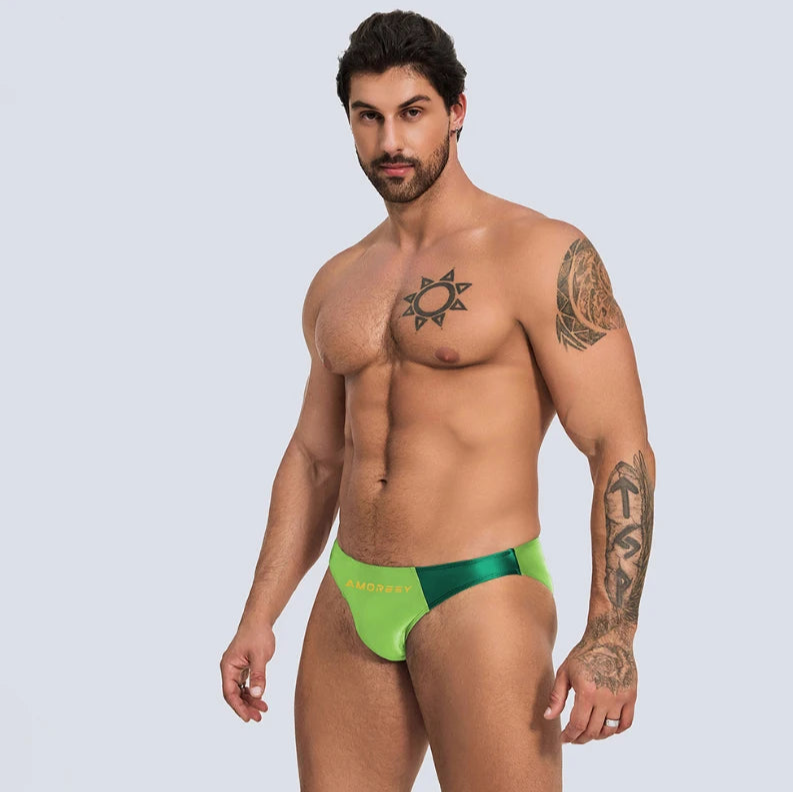 a sexy man in yellow green Men’s Ultra-Slick Wet Werk Mini Swim Briefs - pridevoyageshop.com - gay men’s sexy swim briefs, trunks, board shorts, and bikinis