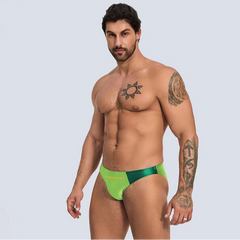 a sexy man in yellow green Men’s Ultra-Slick Wet Werk Mini Swim Briefs - pridevoyageshop.com - gay men’s sexy swim briefs, trunks, board shorts, and bikinis