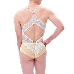 a sexy man wearing a white Mother’s Boudoir Lace Teddy, soft lace details, plunging neckline, feminine-inspired fetish lingerie – pridevoyageshop.com – gay men’s harness, lingerie and fetish wear