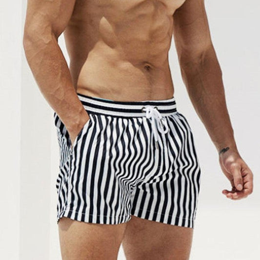 a hot gay man in striped Desmiit Vertical Striped Board Shorts - pridevoyageshop.com - gay men’s underwear and swimwear