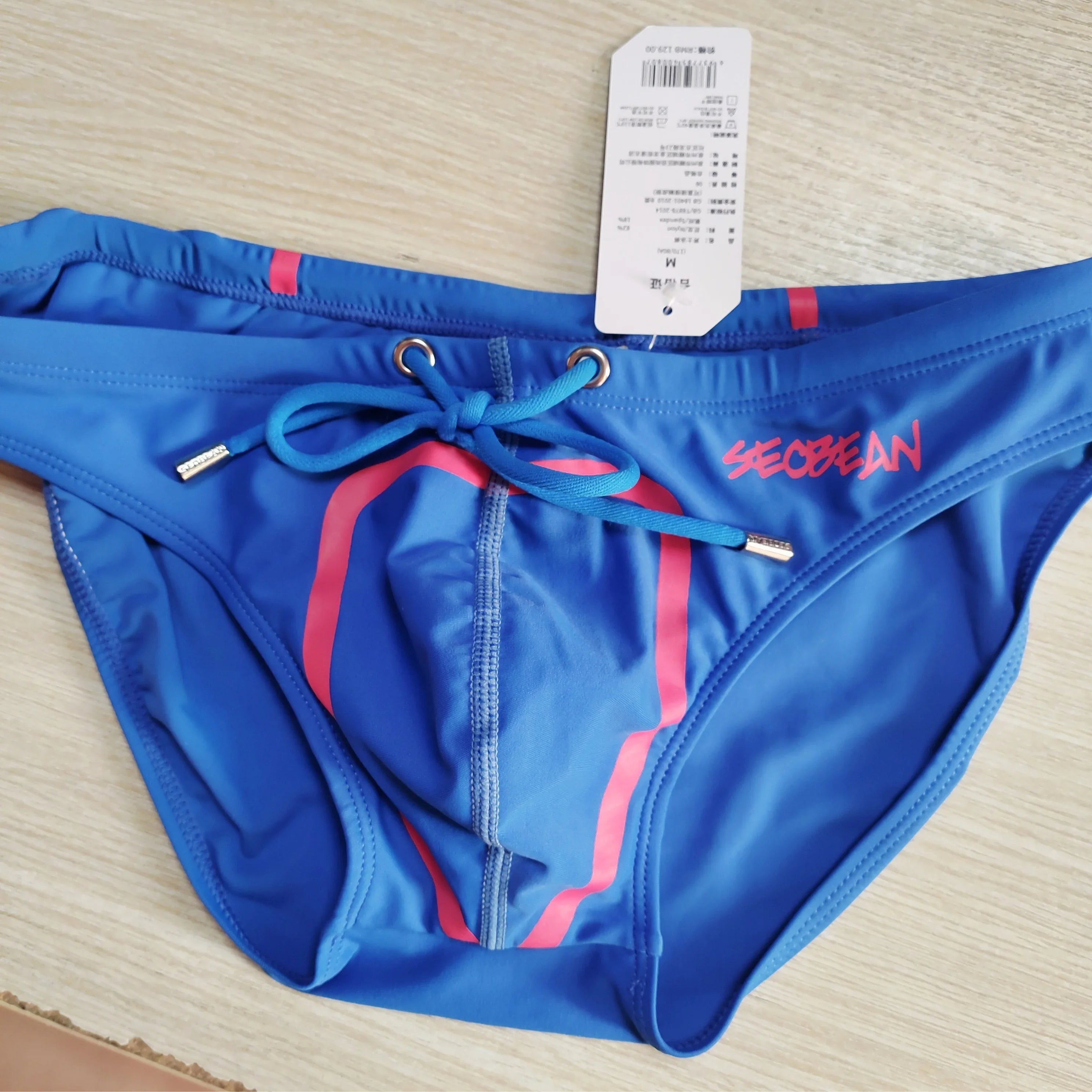 details of blue Men’s Bold Bulge Wave Swim Briefs - pridevoyageshop.com - gay men’s sexy swim briefs, trunks, board shorts, and bikinis