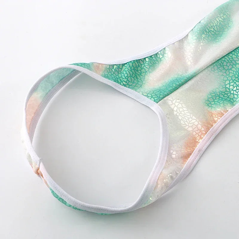 green Riot Cage Frame Singlet flat-lay showing chest cage straps and athletic singlet cut – pridevoyageshop.com – gay men’s harness, lingerie and fetish wear