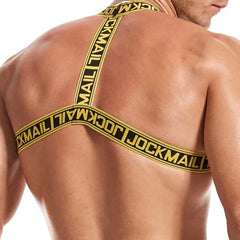 a man in Yellow Jockmail Letter Elastic Chest Harness: Men's Clubwear and Gay Lingerie- pridevoyageshop.com - gay men’s harness, lingerie and fetish wear