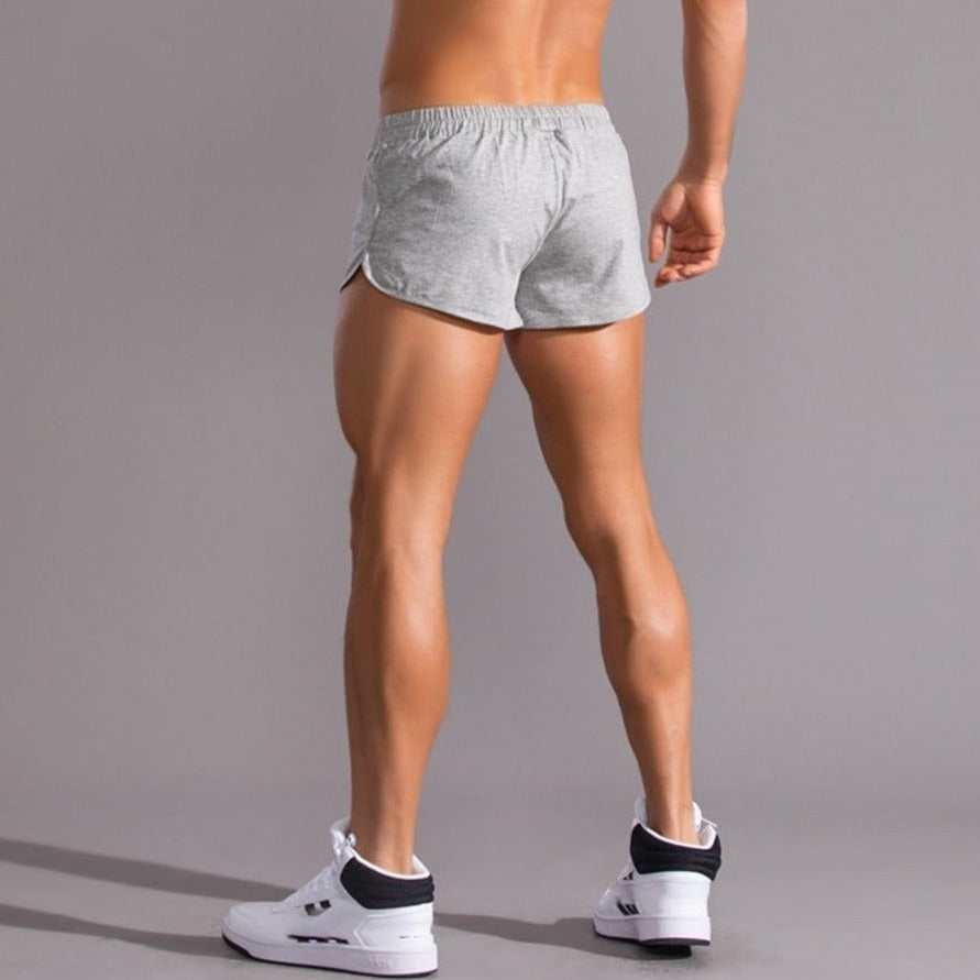 sexy gay man in light gray Gay Shorts | Ultra Short Running Shorts - Men's Activewear, gym short, sport shorts, running shorts- pridevoyageshop.com