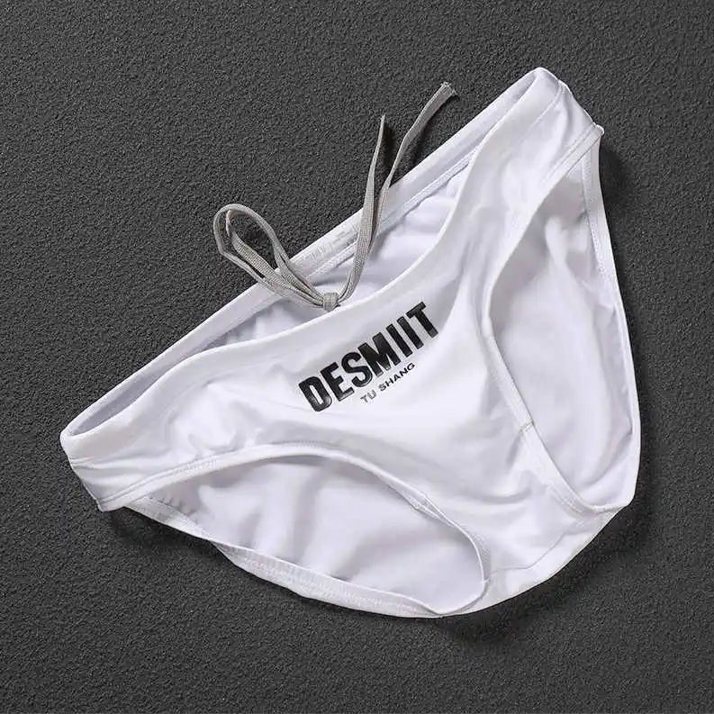 white Desmiit Men’s Sleek Statement Swim Briefs - pridevoyageshop.com - gay men’s sexy swim briefs, trunks, board shorts, and bikinis