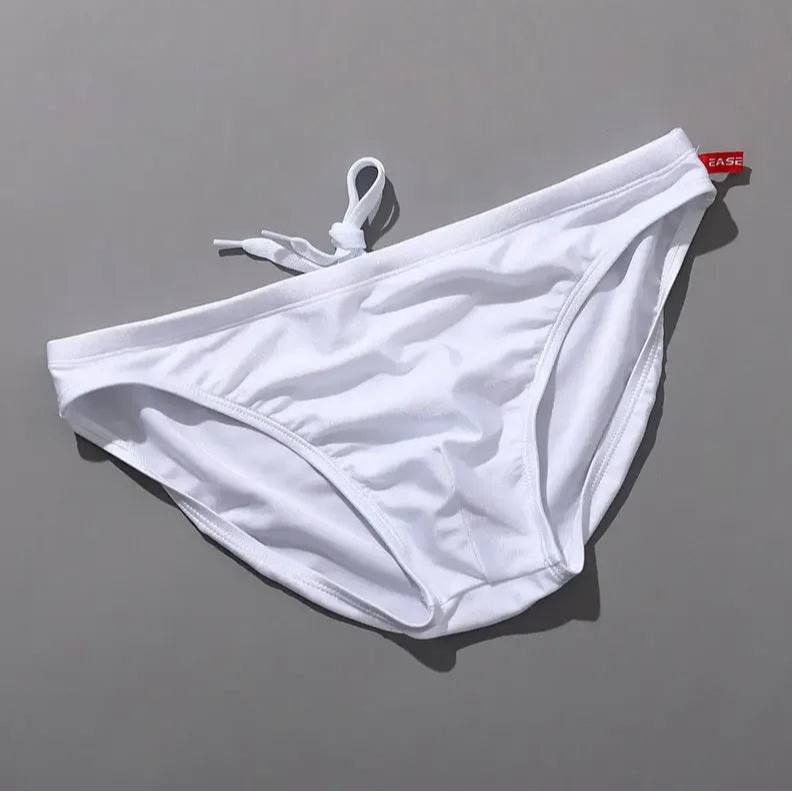 white Men’s Tease-Me Minimal Swim Briefs - pridevoyageshop.com - gay men’s sexy swim briefs, trunks, board shorts, and bikinis